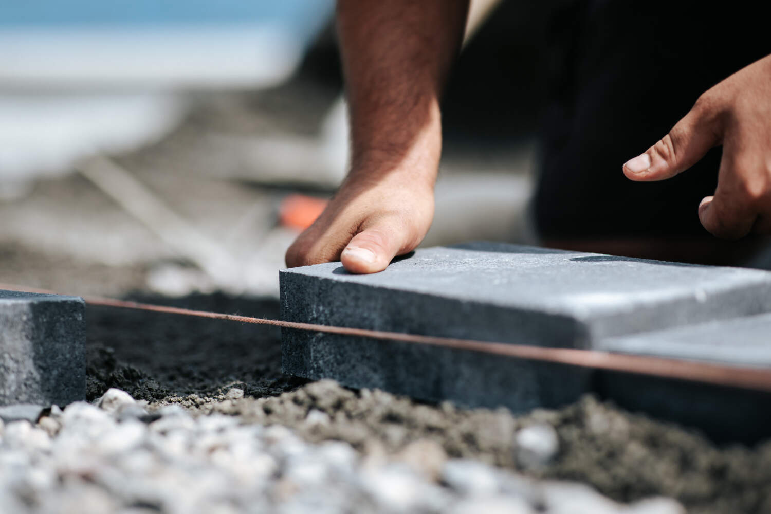 Photo d'un ouvrier entrain de poser des dalles